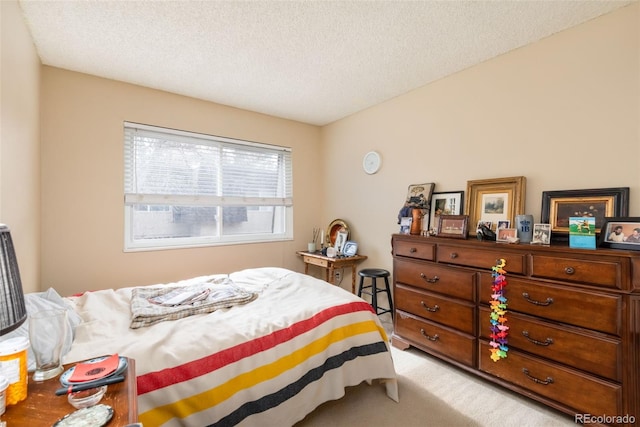 bedroom with a textured ceiling and carpet