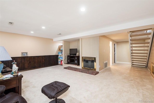 carpeted living area with recessed lighting, stairs, and visible vents