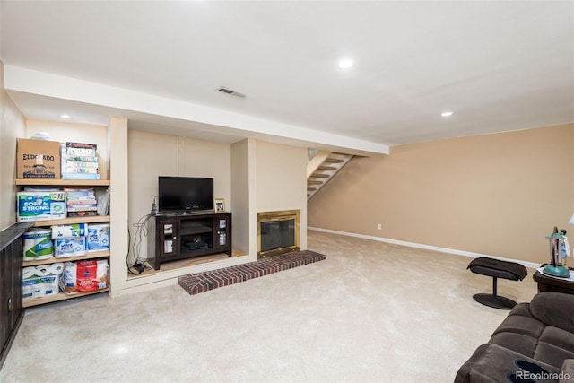 living area with stairs, recessed lighting, visible vents, and carpet