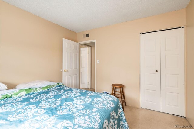 7755 E Quincy Ave Unit T80, Denver, CO 80237 - bedroom featuring light colored carpet and a closet