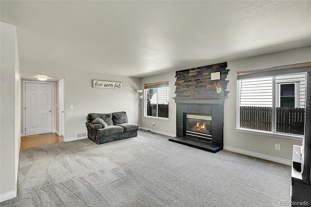 3163 E 133rd Ave, Thornton, CO 80241 - living room featuring carpet flooring, a textured ceiling, and a brick fireplace