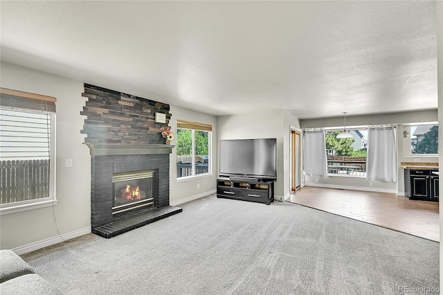 3163 E 133rd Ave, Thornton, CO 80241 - unfurnished living room with carpet, a large fireplace, and a textured ceiling