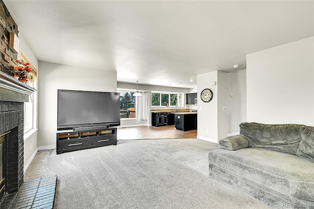 3163 E 133rd Ave, Thornton, CO 80241 - carpeted living area featuring a fireplace and baseboards