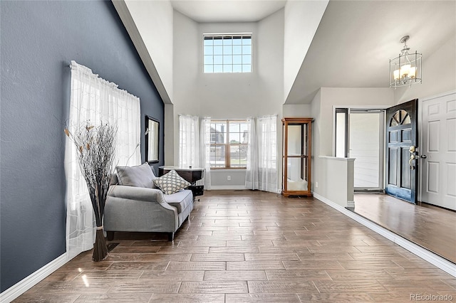 3163 E 133rd Ave, Thornton, CO 80241 - foyer entrance with a chandelier, plenty of natural light, a high ceiling, and wood tiled floors