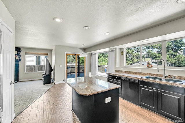 3163 E 133rd Ave, Thornton, CO 80241 - kitchen featuring dark cabinets, dishwasher, a kitchen island, light wood finished floors, and a textured ceiling