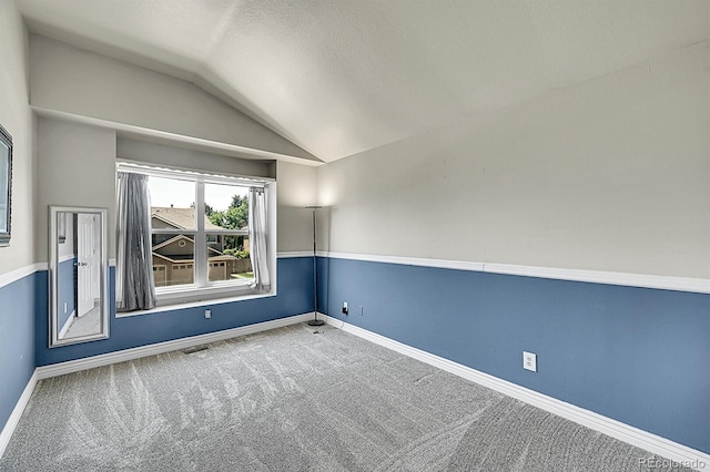 3163 E 133rd Ave, Thornton, CO 80241 - carpeted empty room with vaulted ceiling and a textured ceiling