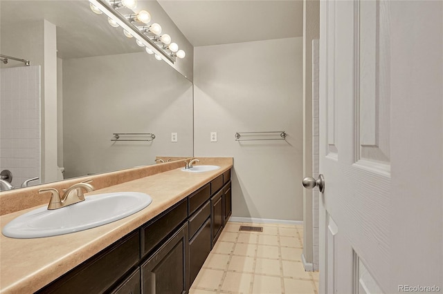3163 E 133rd Ave, Thornton, CO 80241 - bathroom featuring tile patterned floors, double vanity, and a shower