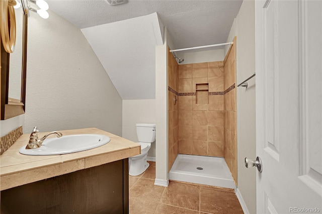 3163 E 133rd Ave, Thornton, CO 80241 - bathroom featuring tile patterned floors, vanity, tiled shower, and a textured ceiling