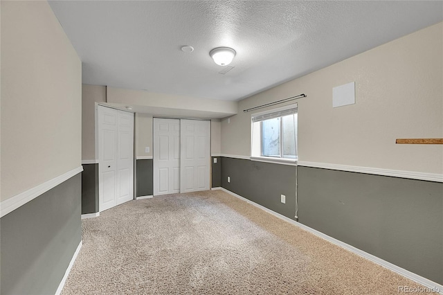 3163 E 133rd Ave, Thornton, CO 80241 - unfurnished bedroom featuring carpet, a textured ceiling, and two closets