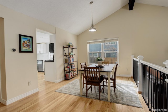 dining space with high vaulted ceiling, light wood finished floors, beamed ceiling, and baseboards