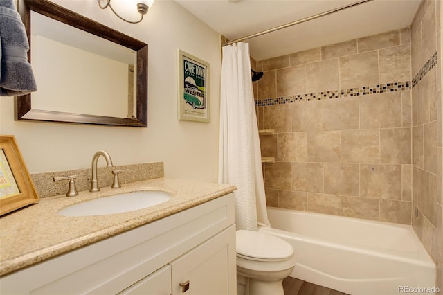 bathroom with toilet, shower / bathtub combination with curtain, and vanity