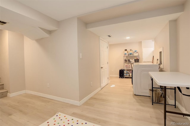 interior space with light wood-style flooring, separate washer and dryer, visible vents, baseboards, and stairs