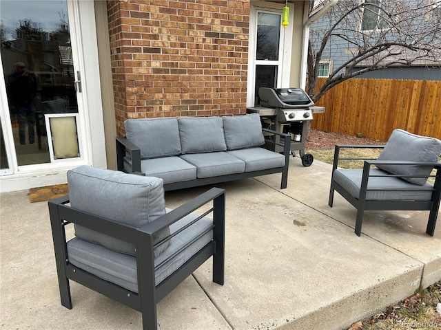 view of patio / terrace with fence, an outdoor living space, and a grill