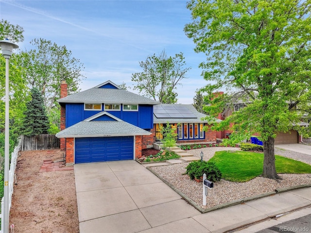 12355 E Arkansas Pl, Aurora, CO 80012 - tri-level home with brick siding, a garage, fence, solar panels, and concrete driveway