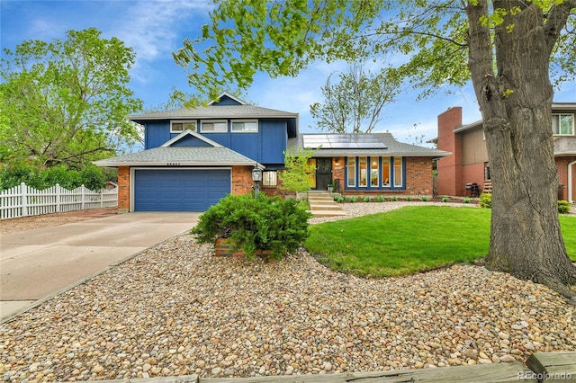 12355 E Arkansas Pl, Aurora, CO 80012 - tri-level home featuring brick siding, driveway, solar panels, an attached garage, and roof with shingles