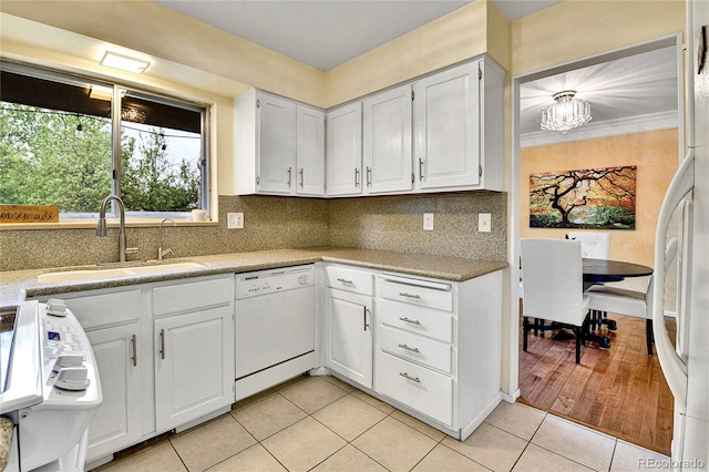 12355 E Arkansas Pl, Aurora, CO 80012 - kitchen with white appliances, a sink, light tile patterned flooring, decorative backsplash, and light countertops