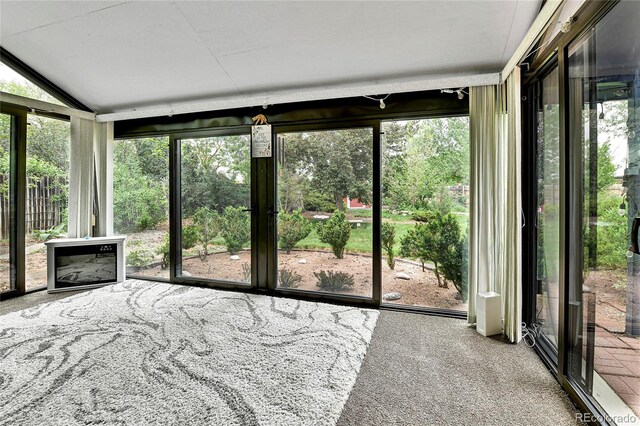 12355 E Arkansas Pl, Aurora, CO 80012 - unfurnished sunroom with plenty of natural light, carpet, and lofted ceiling