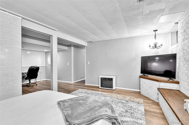 12355 E Arkansas Pl, Aurora, CO 80012 - bedroom with wood finished floors, heating unit, an office area, and a fireplace