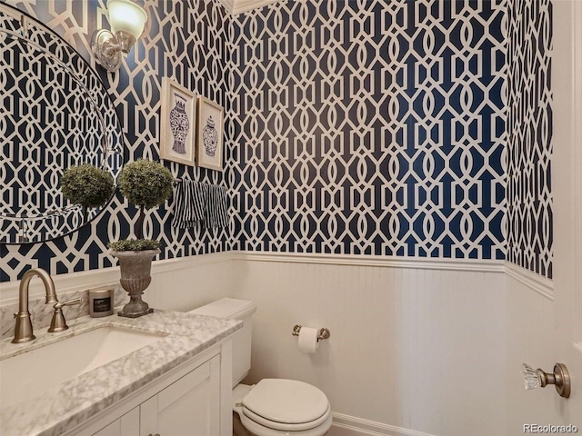 930 Kearney St, Denver, CO 80220 - half bathroom featuring wainscoting, wallpapered walls, and vanity