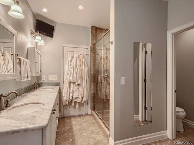 930 Kearney St, Denver, CO 80220 - full bathroom with double vanity, a shower stall, and recessed lighting