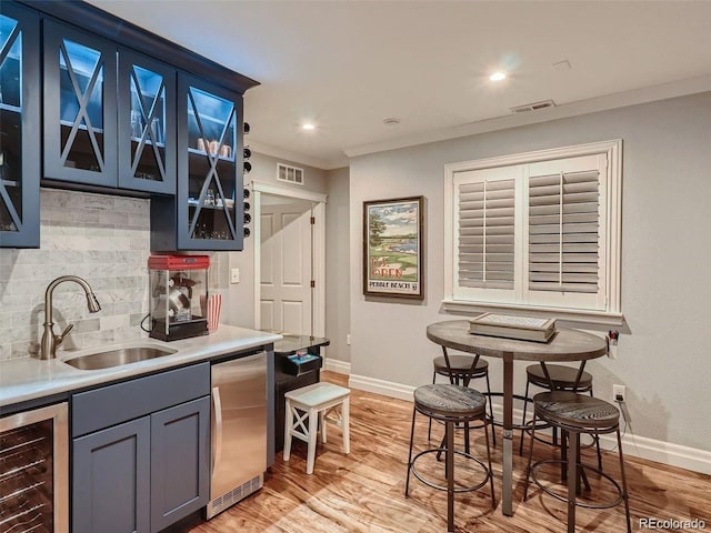 930 Kearney St, Denver, CO 80220 - kitchen with beverage cooler, fridge, tasteful backsplash, ornamental molding, and light countertops