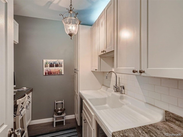 930 Kearney St, Denver, CO 80220 - kitchen featuring tasteful backsplash, light countertops, and white cabinets