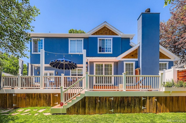 930 Kearney St, Denver, CO 80220 - rear view of house with a wooden deck, stairs, a chimney, and stucco siding