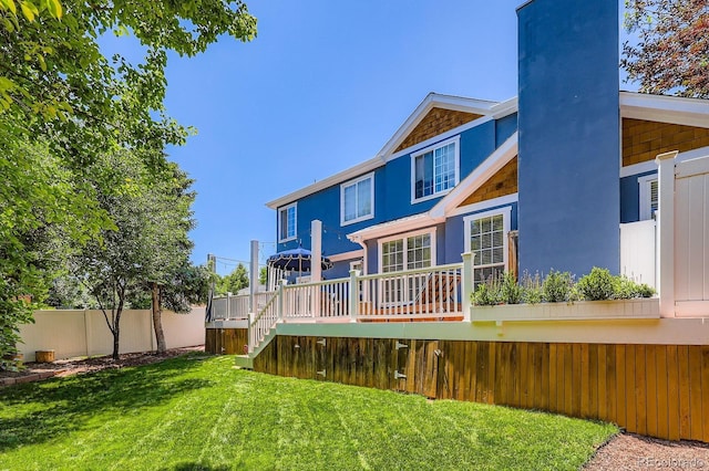 930 Kearney St, Denver, CO 80220 - back of house featuring a wooden deck, stairway, a chimney, and stucco siding