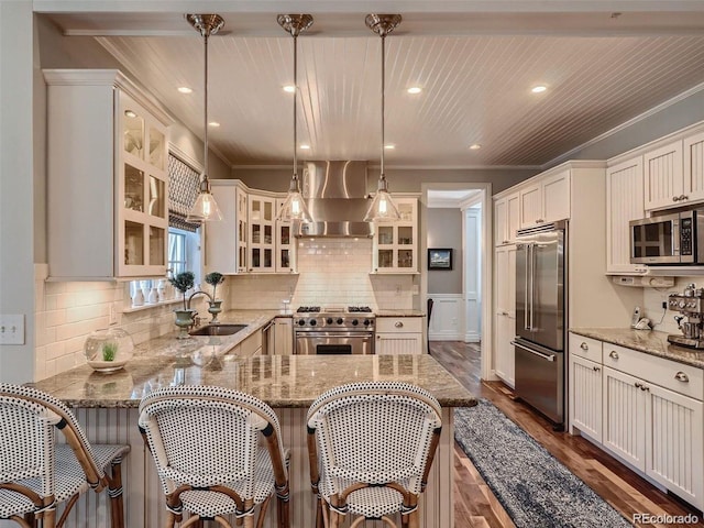 930 Kearney St, Denver, CO 80220 - kitchen with premium appliances, wall chimney range hood, dark wood-style floors, ornamental molding, and light stone countertops