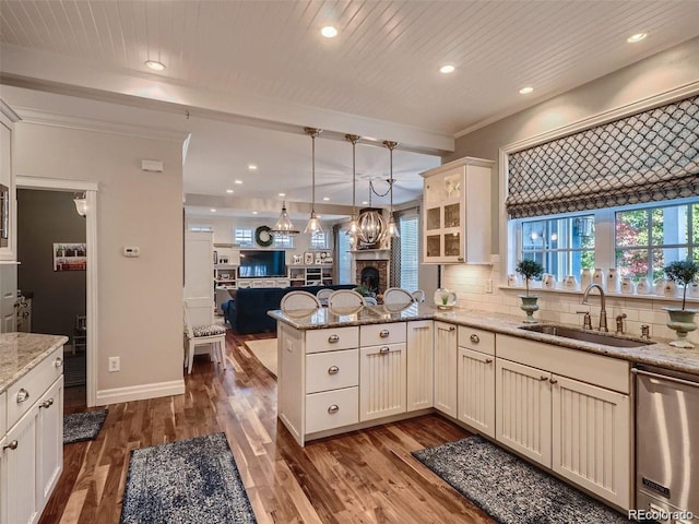 930 Kearney St, Denver, CO 80220 - kitchen featuring dishwasher, open floor plan, recessed lighting, a peninsula, and light stone counters