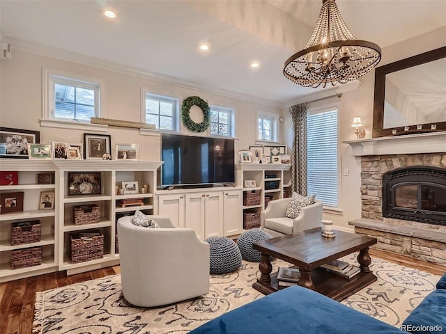 930 Kearney St, Denver, CO 80220 - living room with ornamental molding, wood finished floors, a chandelier, recessed lighting, and a stone fireplace