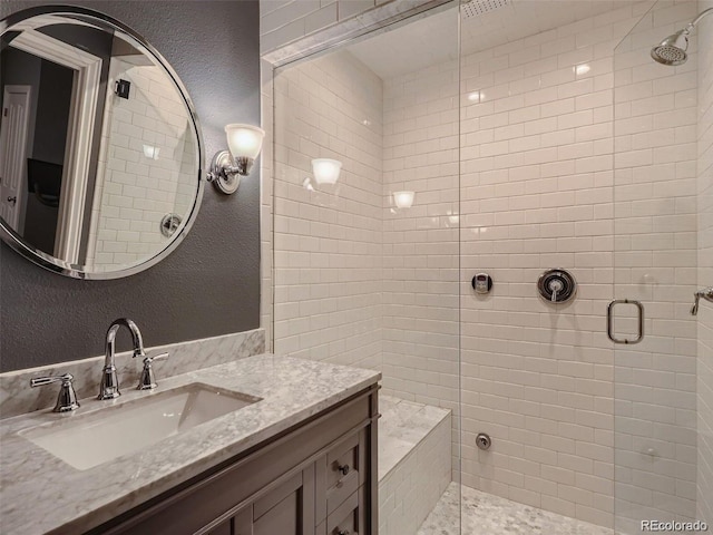 930 Kearney St, Denver, CO 80220 - bathroom with a shower stall, vanity, and a textured wall