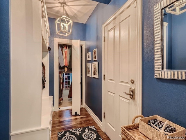 930 Kearney St, Denver, CO 80220 - foyer with dark wood-type flooring, a textured wall, and a chandelier