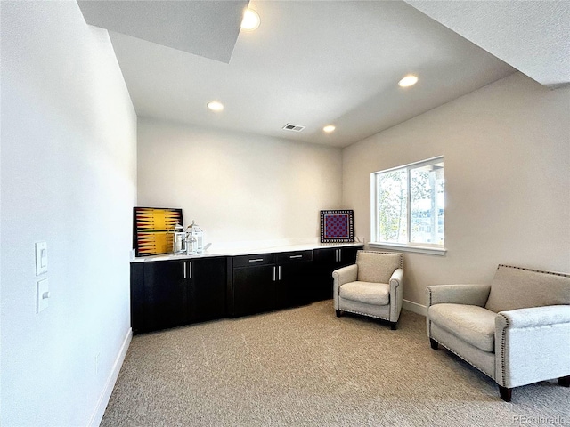 sitting room featuring light colored carpet