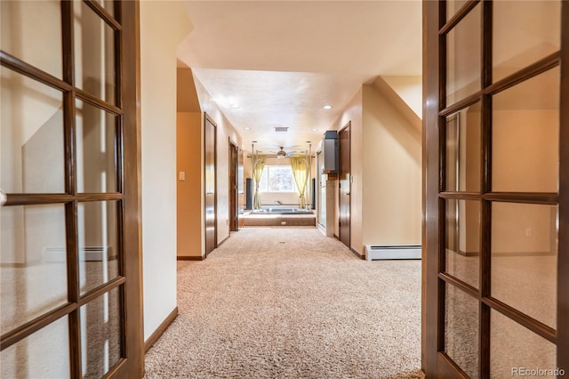 hall featuring a baseboard radiator and light colored carpet