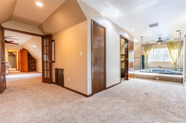 additional living space featuring french doors, ceiling fan, lofted ceiling, and carpet