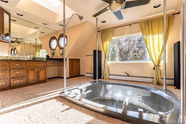 bathroom featuring vanity, a baseboard heating unit, a tub, and ceiling fan