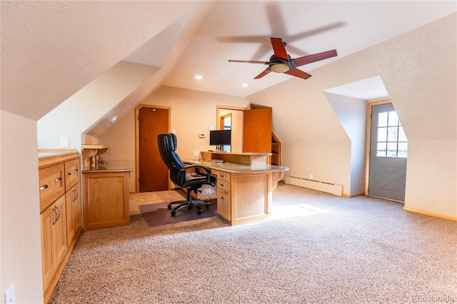 carpeted office space with lofted ceiling, a baseboard heating unit, and ceiling fan