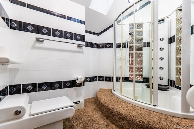 bathroom featuring a skylight and enclosed tub / shower combo