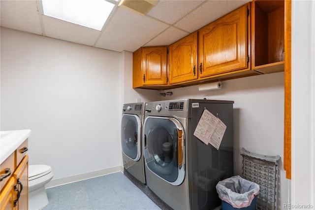 clothes washing area with washing machine and clothes dryer