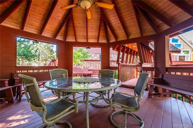 sunroom featuring vaulted ceiling with beams, wooden ceiling, and ceiling fan