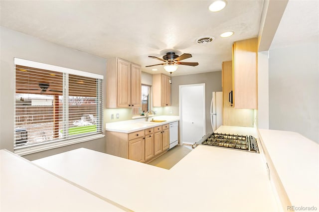 kitchen with ceiling fan, sink, white appliances, and light brown cabinetry