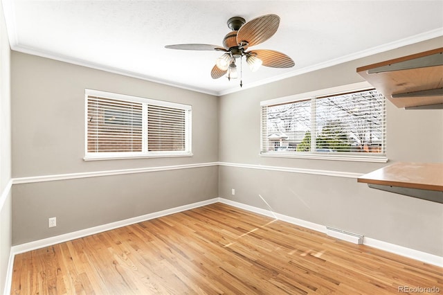 spare room featuring ornamental molding, ceiling fan, and wood-type flooring