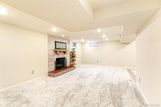 unfurnished living room with carpet and a brick fireplace