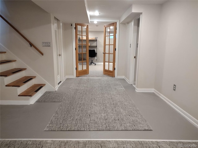 interior space featuring french doors and concrete flooring