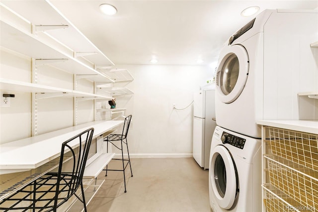 laundry area featuring stacked washer / dryer