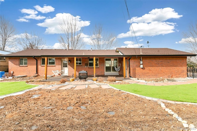 rear view of house featuring a yard and a patio area