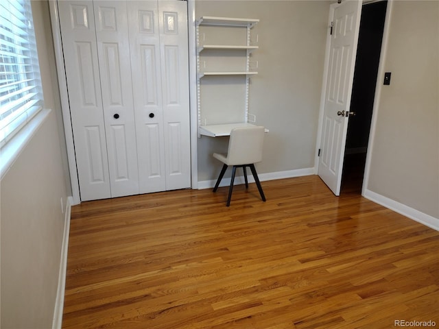 unfurnished bedroom with light hardwood / wood-style flooring and a closet