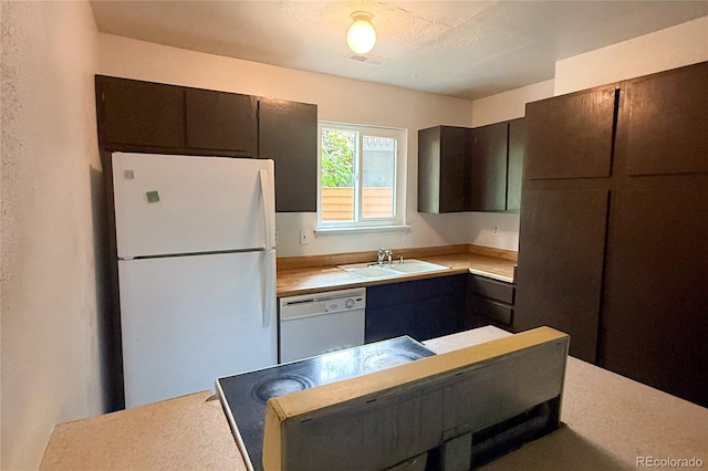 2261 S Buckley Rd Unit 102, Aurora, CO 80013 - kitchen featuring white appliances, a sink, and light countertops