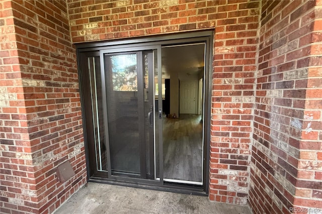 2261 S Buckley Rd Unit 102, Aurora, CO 80013 - doorway to property featuring brick siding